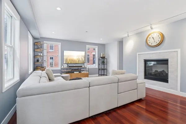 a living room with furniture and a fireplace