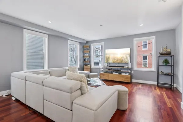 a living room with furniture and a flat screen tv