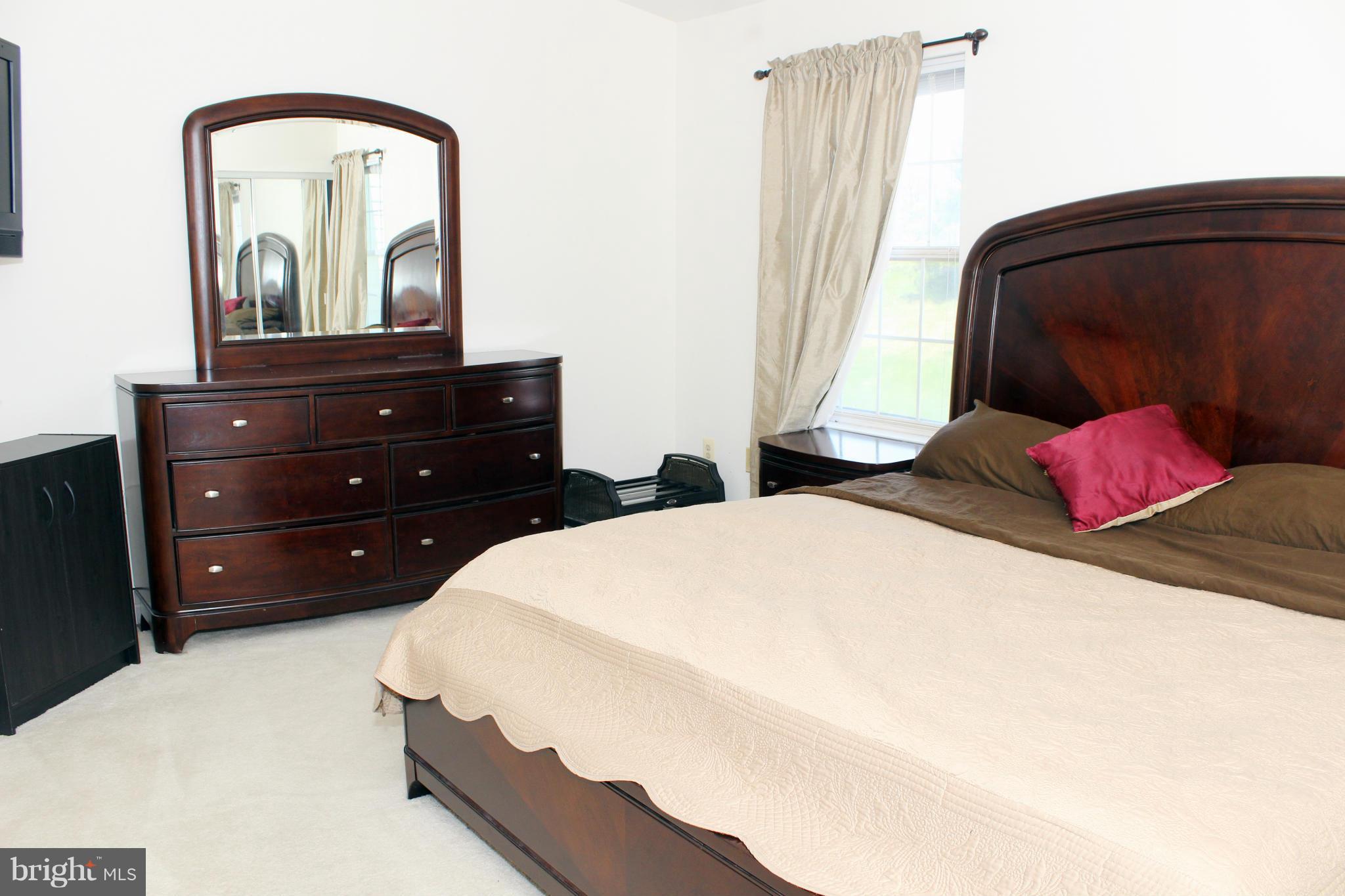 12318 Sandy Point Court Silver Spring, MD 20904 - Photo 14 of 29 a bedroom with a bed and a mirror