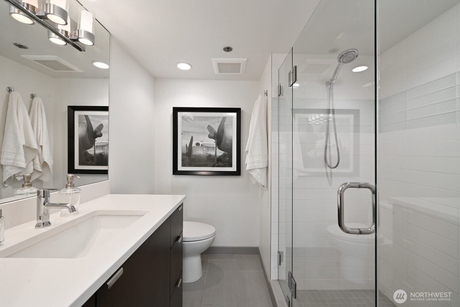 121 Vine Street, Unit 703 Seattle, WA 98121 - Photo 17 of 37 a bathroom with a sink a toilet and shower