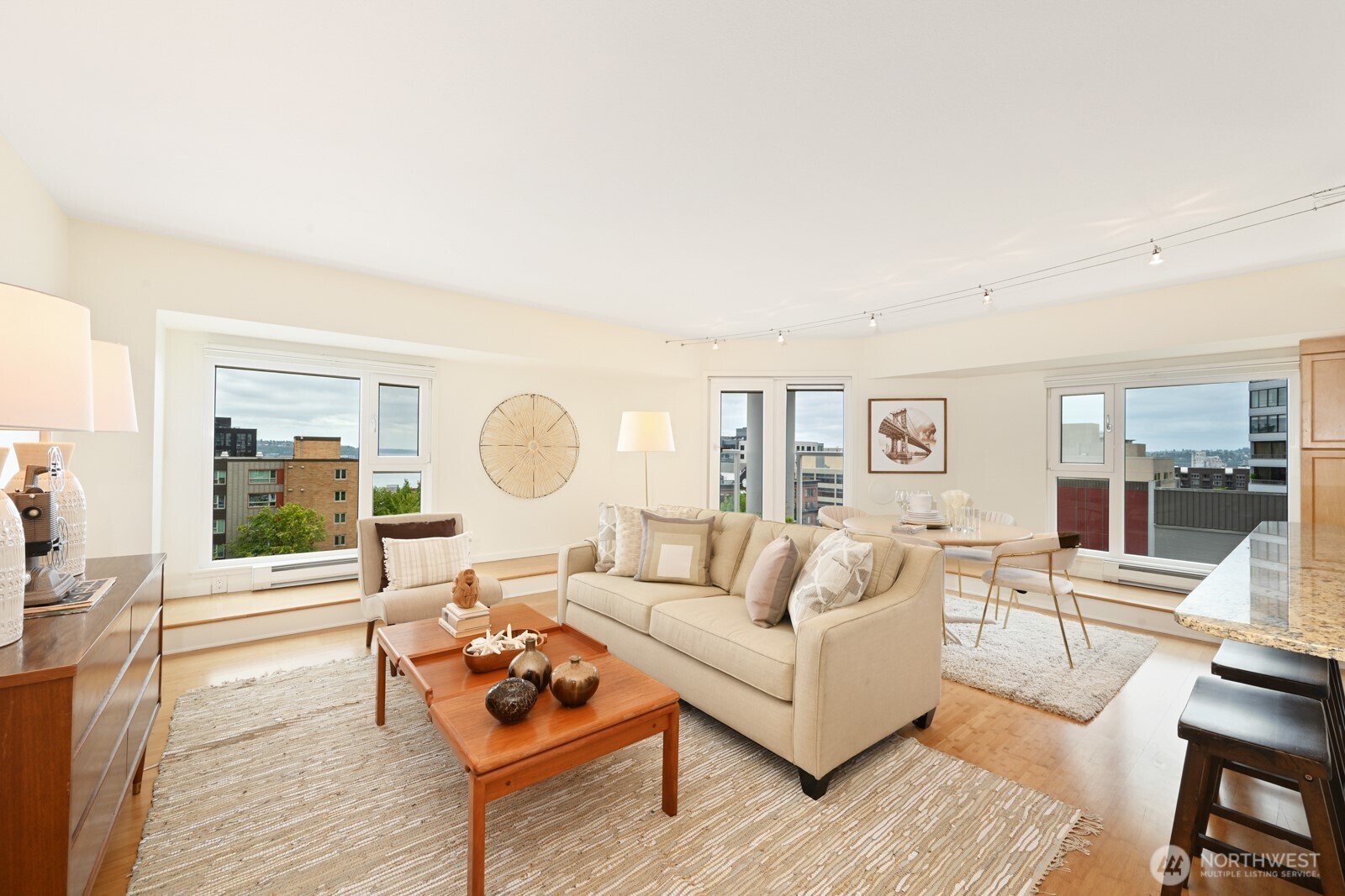 121 Vine Street, Unit 703 Seattle, WA 98121 - Photo 3 of 37 a living room with furniture and a wooden floor
