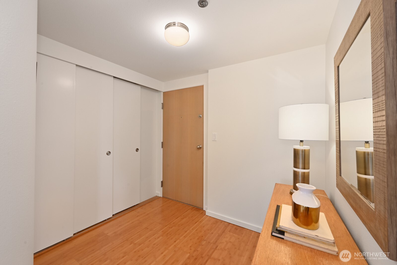 121 Vine Street, Unit 703 Seattle, WA 98121 - Photo 5 of 37 a room with a bed and wooden floor