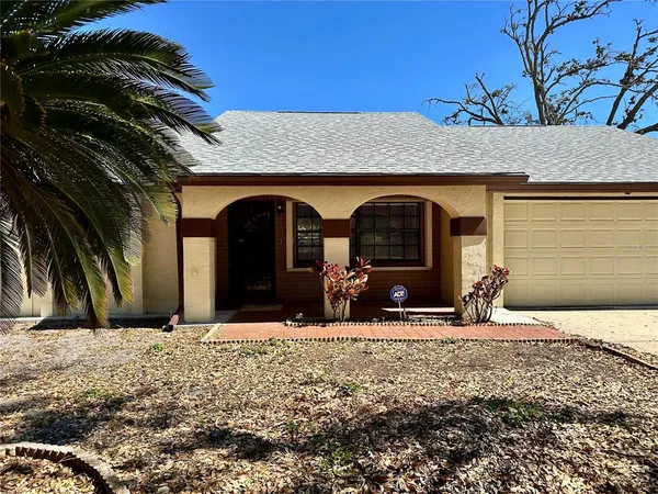 a view of house with car parked