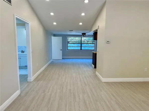 wooden floor in an empty room with a window