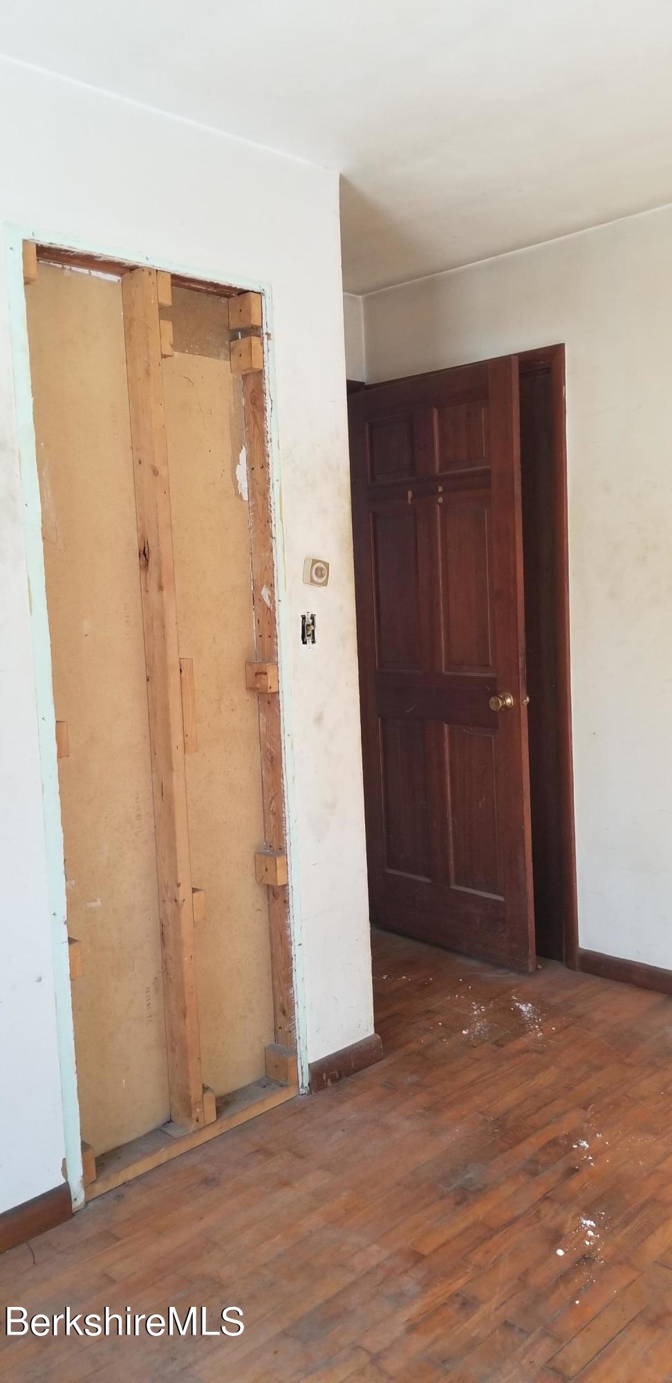 236 Sandisfield Road Sandisfield, MA 01255 - Photo 3 of 8 an empty room with an entryway door