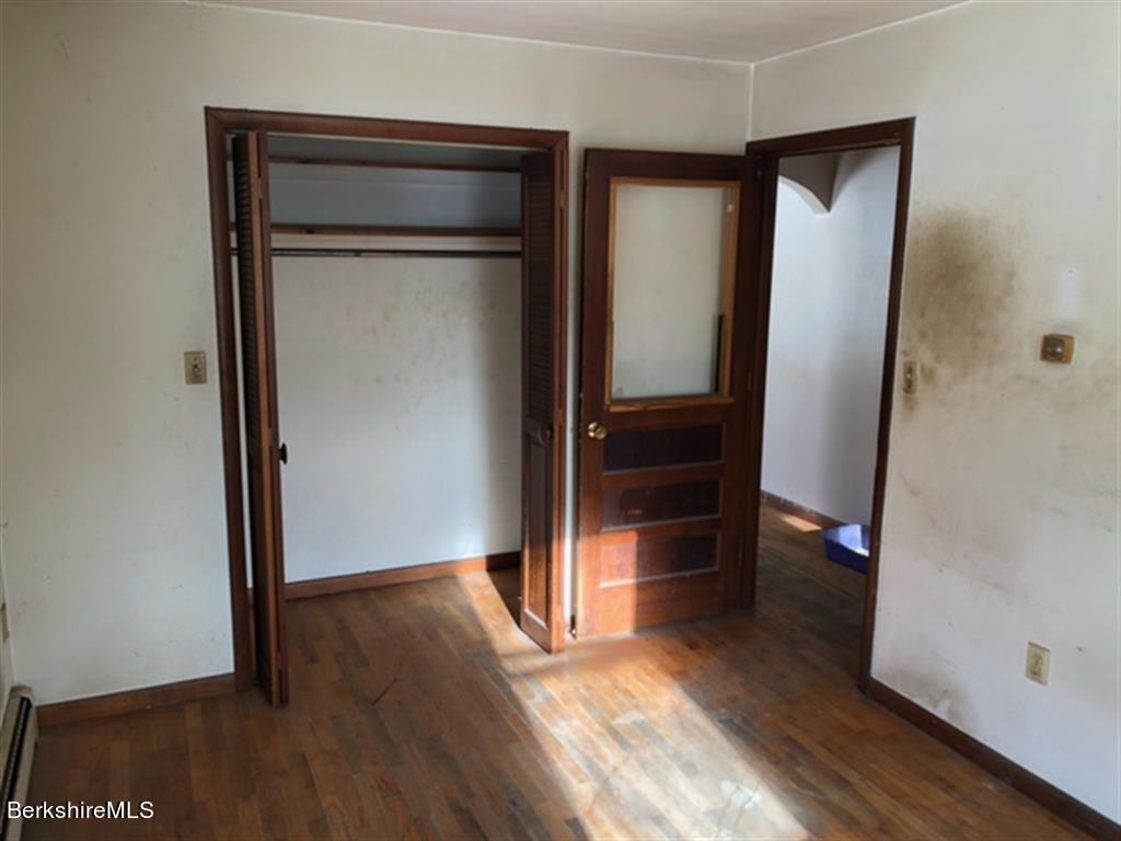 236 Sandisfield Road Sandisfield, MA 01255 - Photo 8 of 8 an empty room with wooden floor and closet