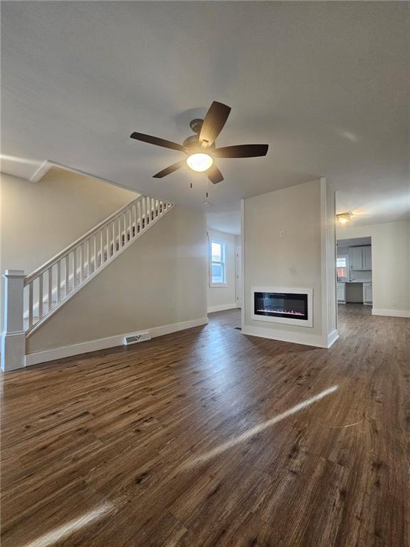 539 Walnut Street Vandergrift, PA 15690 - Photo 2 of 35 a view of an empty room with wooden floor and a ceiling fan