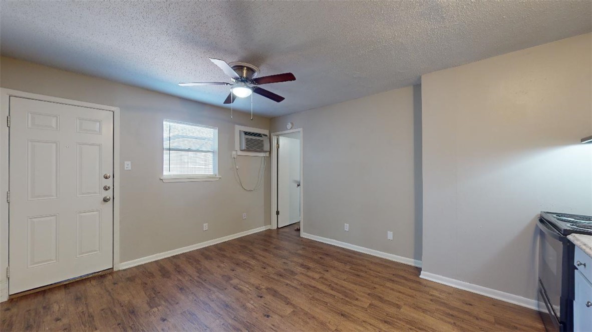 500 Foch Street, Unit 15 Bryan, TX 77801 - Photo 3 of 12 a view of empty room with wooden floor and fan