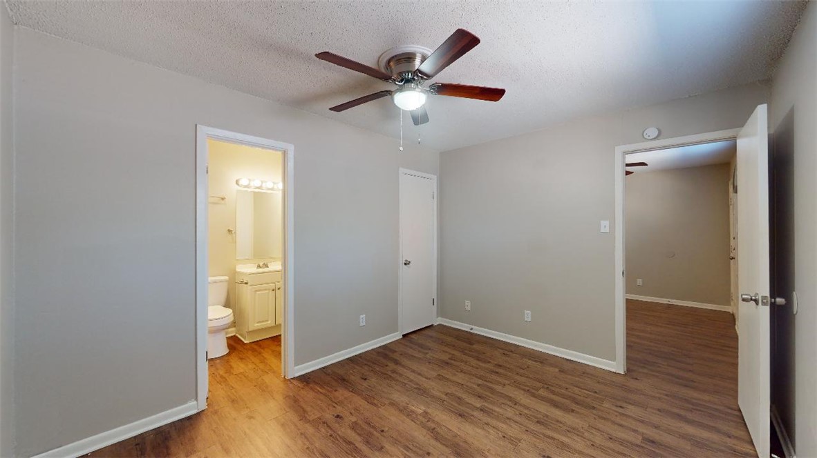 500 Foch Street, Unit 15 Bryan, TX 77801 - Photo 5 of 12 wooden floor in an empty room with a window