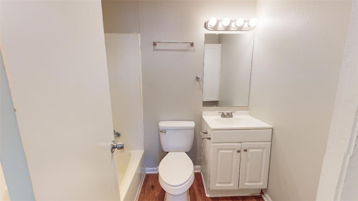 500 Foch Street, Unit 15 Bryan, TX 77801 - Photo 9 of 12 a bathroom with a toilet a sink and mirror