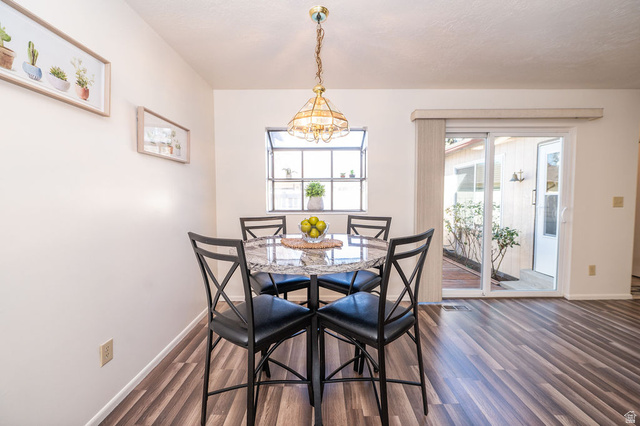 621 Coachman Way Riverdale, UT 84405 - Photo 12 of 38 Dining area with dark wood-type flooring and suspended lighting