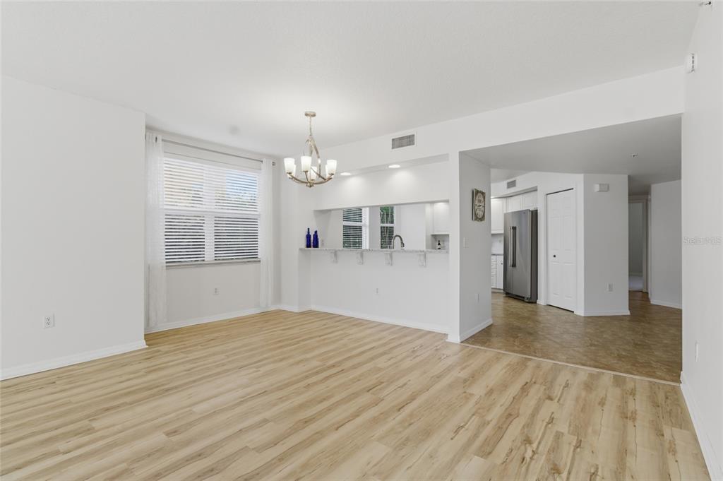 960 Starkey Road, Unit 3106 Largo, FL 33771 - Photo 12 of 39 a view of a livingroom with wooden floor and kitchen space