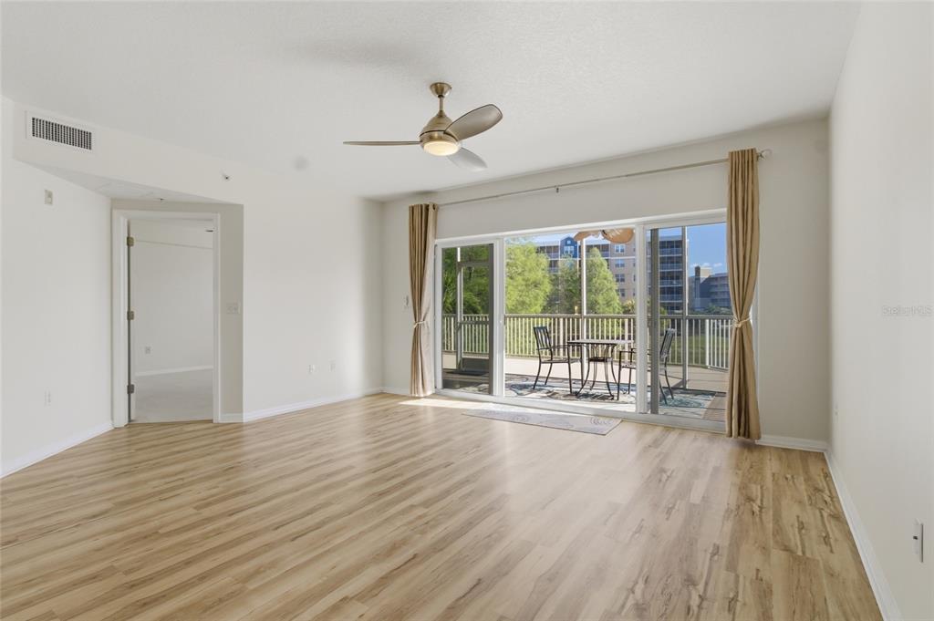 960 Starkey Road, Unit 3106 Largo, FL 33771 - Photo 14 of 39 a view of an empty room with wooden floor and a window
