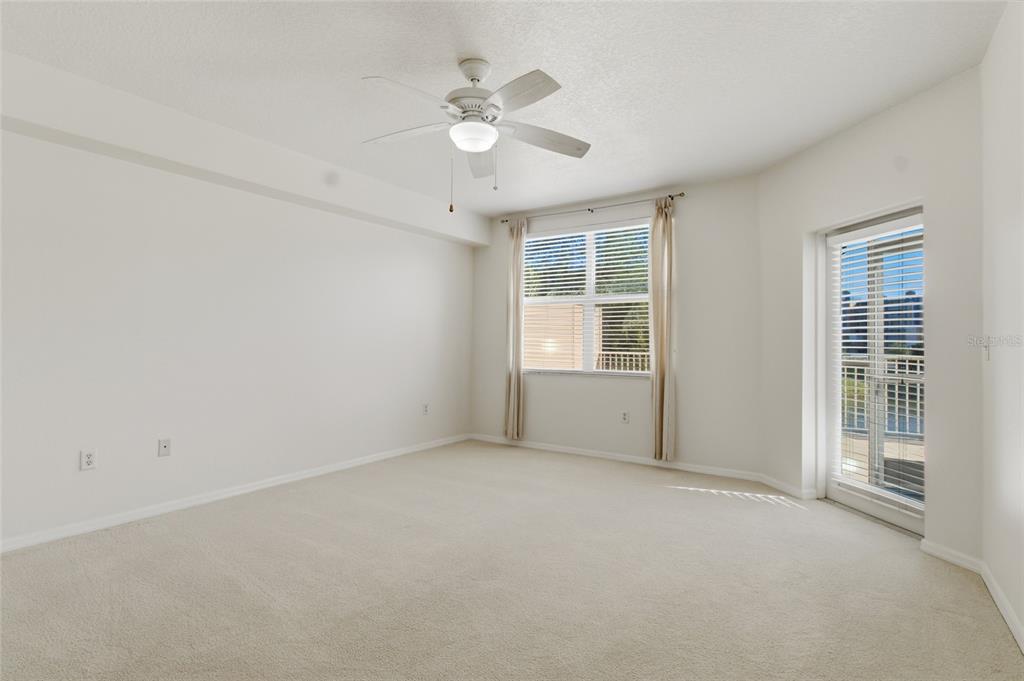 960 Starkey Road, Unit 3106 Largo, FL 33771 - Photo 18 of 39 an empty room with windows and fan