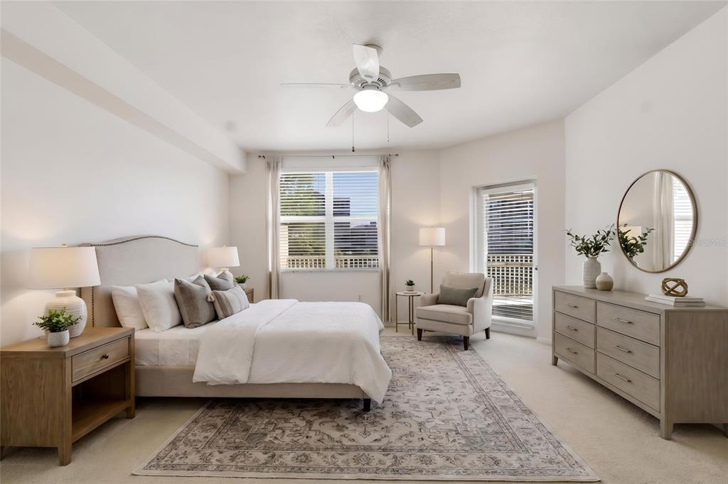 960 Starkey Road, Unit 3106 Largo, FL 33771 - Photo 21 of 39 a bedroom with a large bed and a chandelier