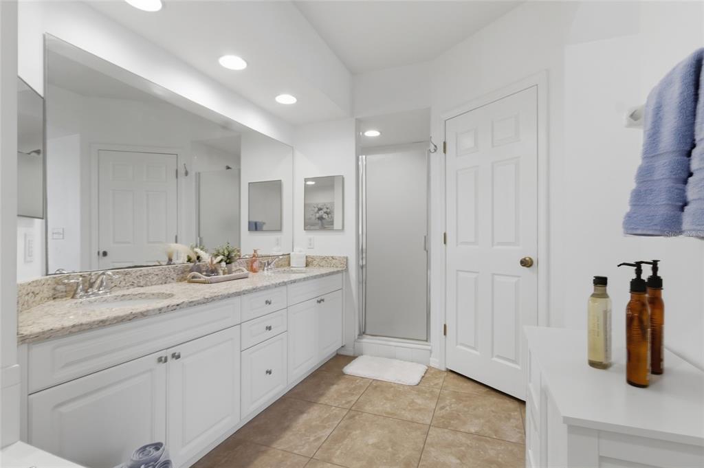960 Starkey Road, Unit 3106 Largo, FL 33771 - Photo 23 of 39 a bathroom with a granite countertop sink and a mirror