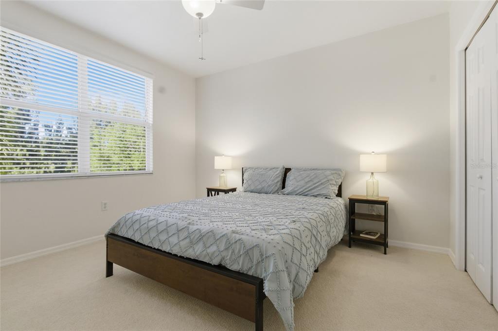 960 Starkey Road, Unit 3106 Largo, FL 33771 - Photo 25 of 39 a bedroom with a bed and a lamp