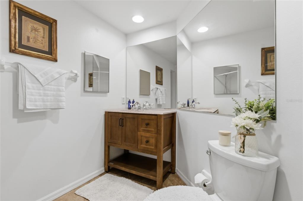 960 Starkey Road, Unit 3106 Largo, FL 33771 - Photo 27 of 39 a bathroom with a sink mirror and toilet