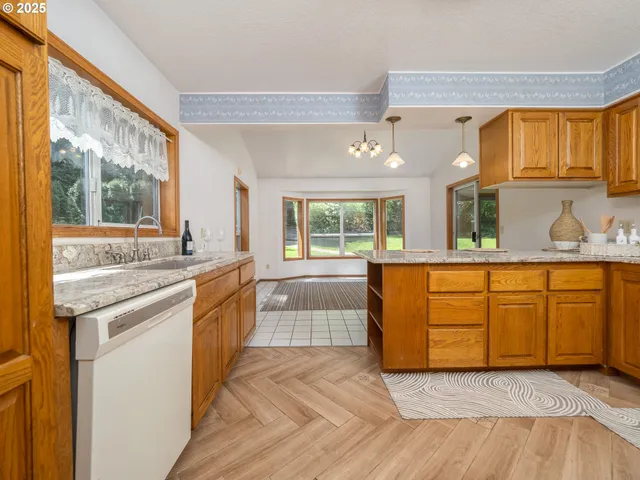 a kitchen with granite countertop a sink and cabinets
