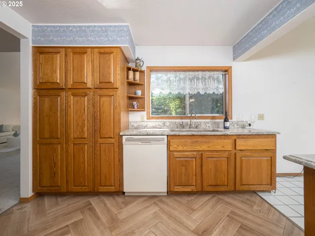 an empty room with wooden floor and cabinet