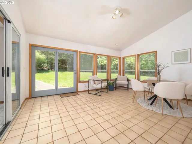 a living room with furniture and a floor to ceiling window