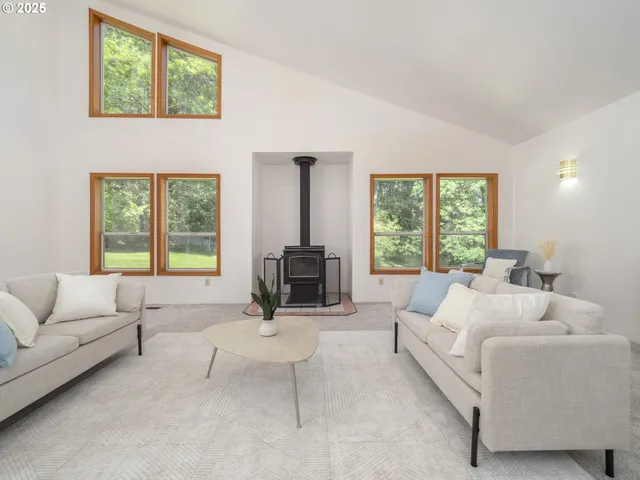 a living room with furniture a large window and a flat screen tv