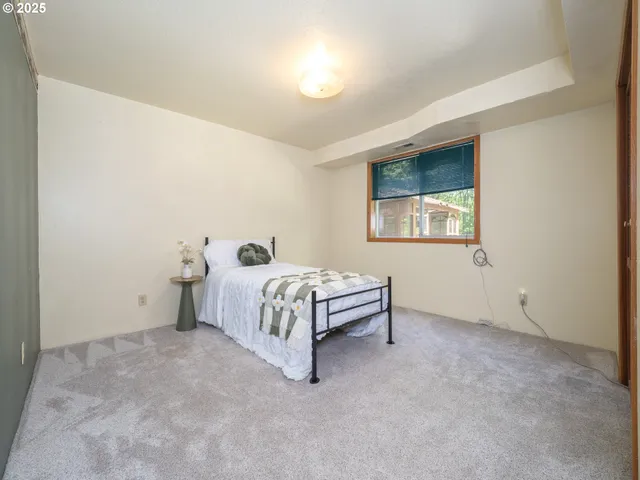 a spacious bedroom with a bed and a window