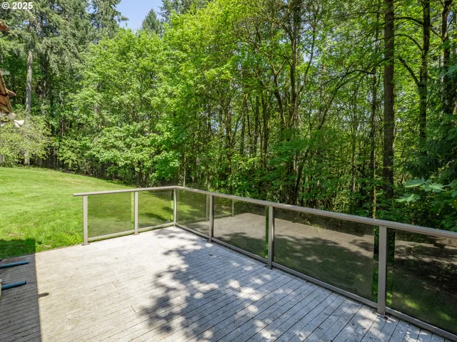 a view of a fence and a trees beside a park