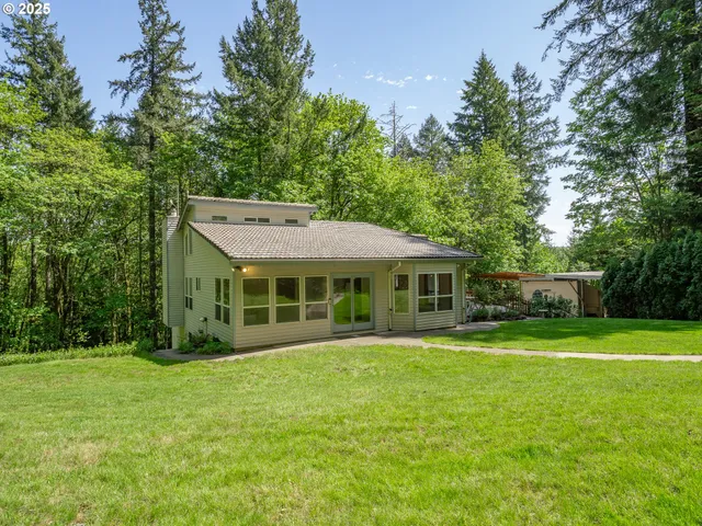 a view of a house with yard and sitting area