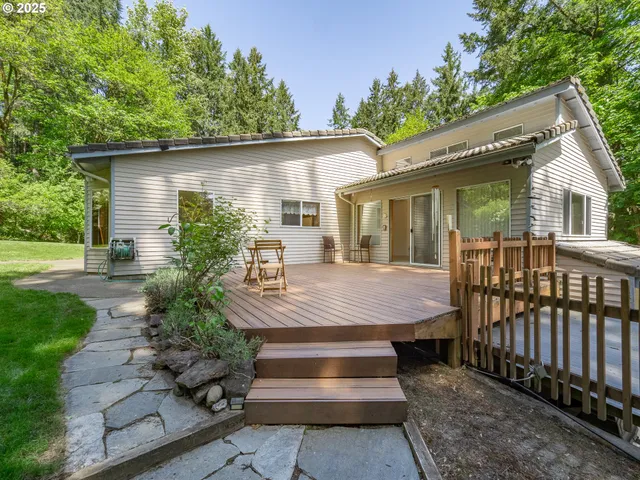 a view of a house with backyard and sitting area