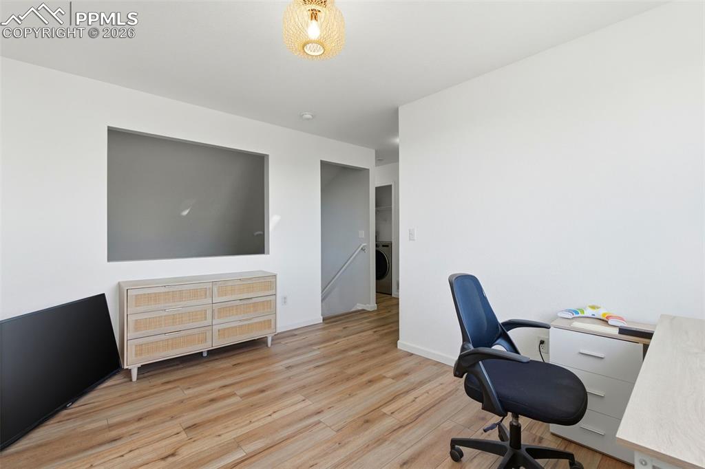 11175 Berry Farm Road Fountain, CO 80817 - Photo 11 of 40 a view of a workspace with furniture and wooden floor