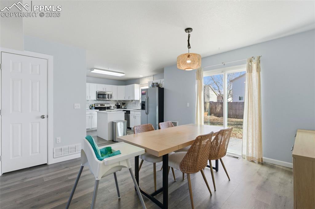 11175 Berry Farm Road Fountain, CO 80817 - Photo 20 of 40 a view of a dining room with furniture window and wooden floor