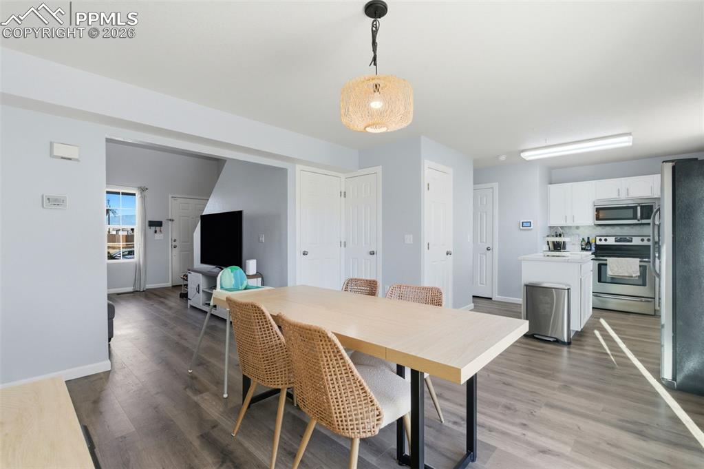 11175 Berry Farm Road Fountain, CO 80817 - Photo 22 of 40 a view of a dining room with furniture and wooden floor