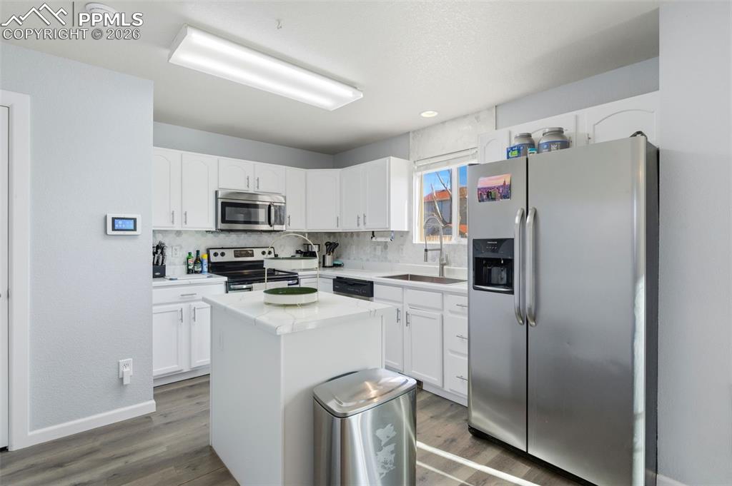11175 Berry Farm Road Fountain, CO 80817 - Photo 24 of 40 a kitchen with cabinets stainless steel appliances and a refrigerator