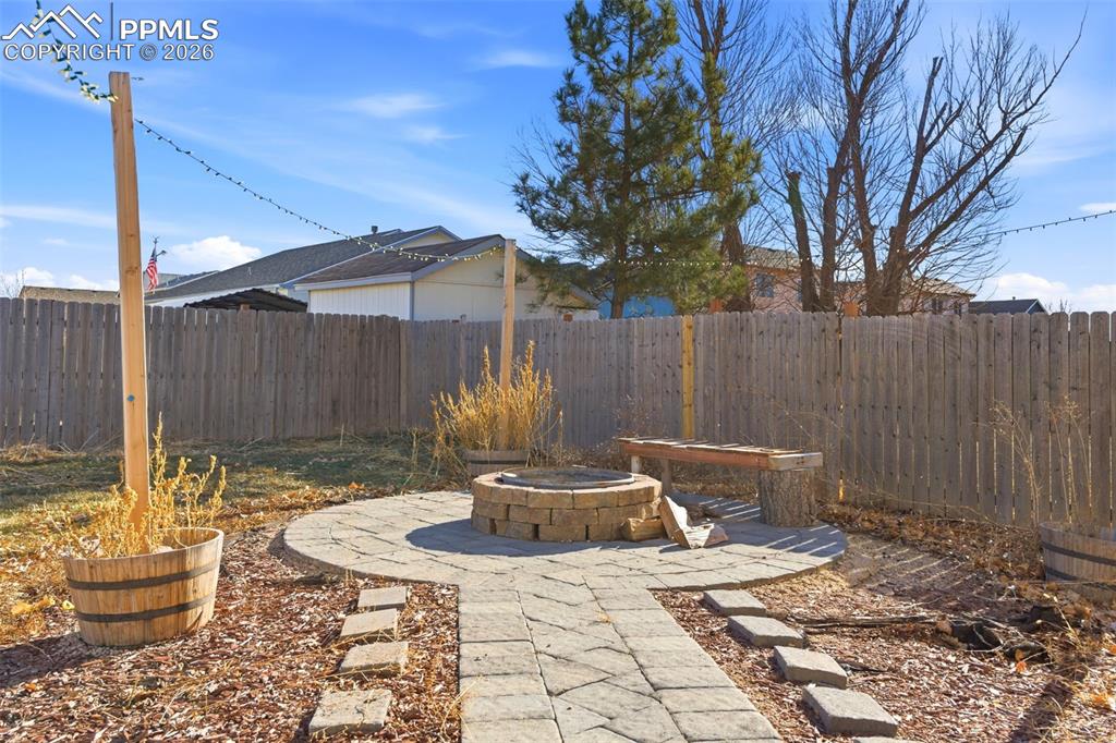 11175 Berry Farm Road Fountain, CO 80817 - Photo 31 of 40 a view of a patio with table and chairs potted plants and wooden fence