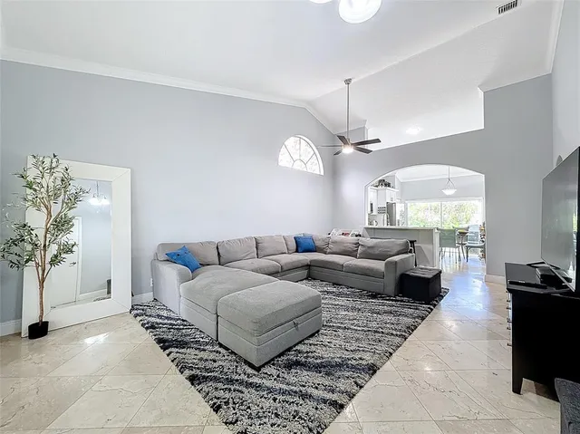 a living room with furniture and a chandelier