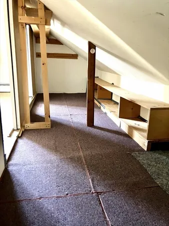 a view of a room with wooden floor and cabinet