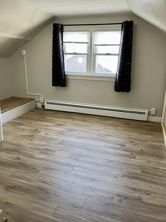 a view of a room with wooden floor and cabinet
