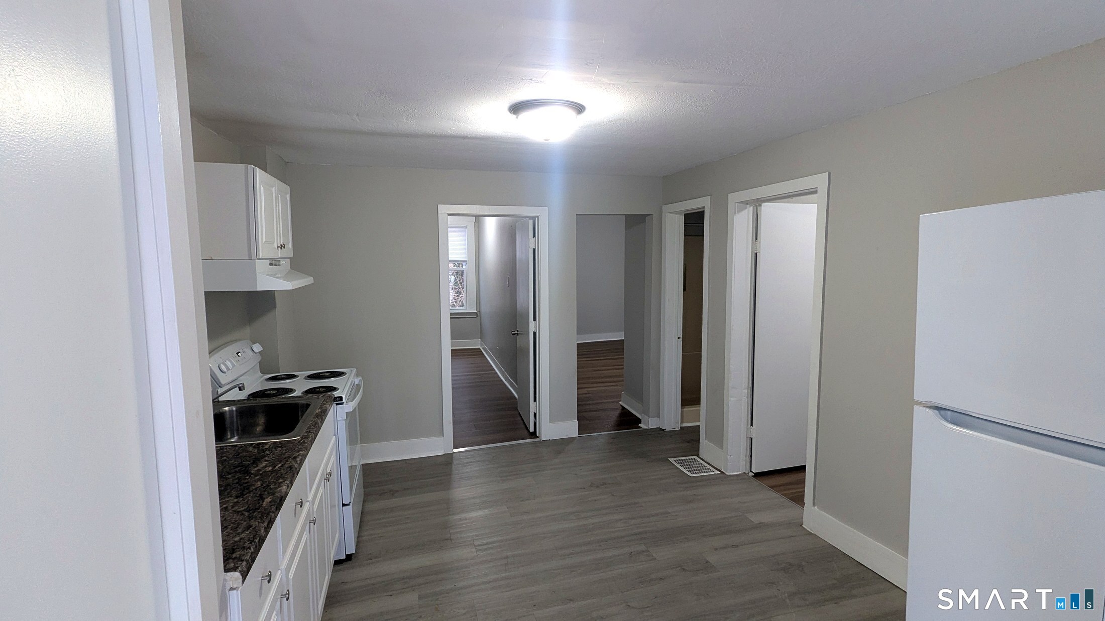 116 Old Foxon Road East Haven, CT 06513 - Photo 12 of 35 a view of a kitchen with a sink and refrigerator
