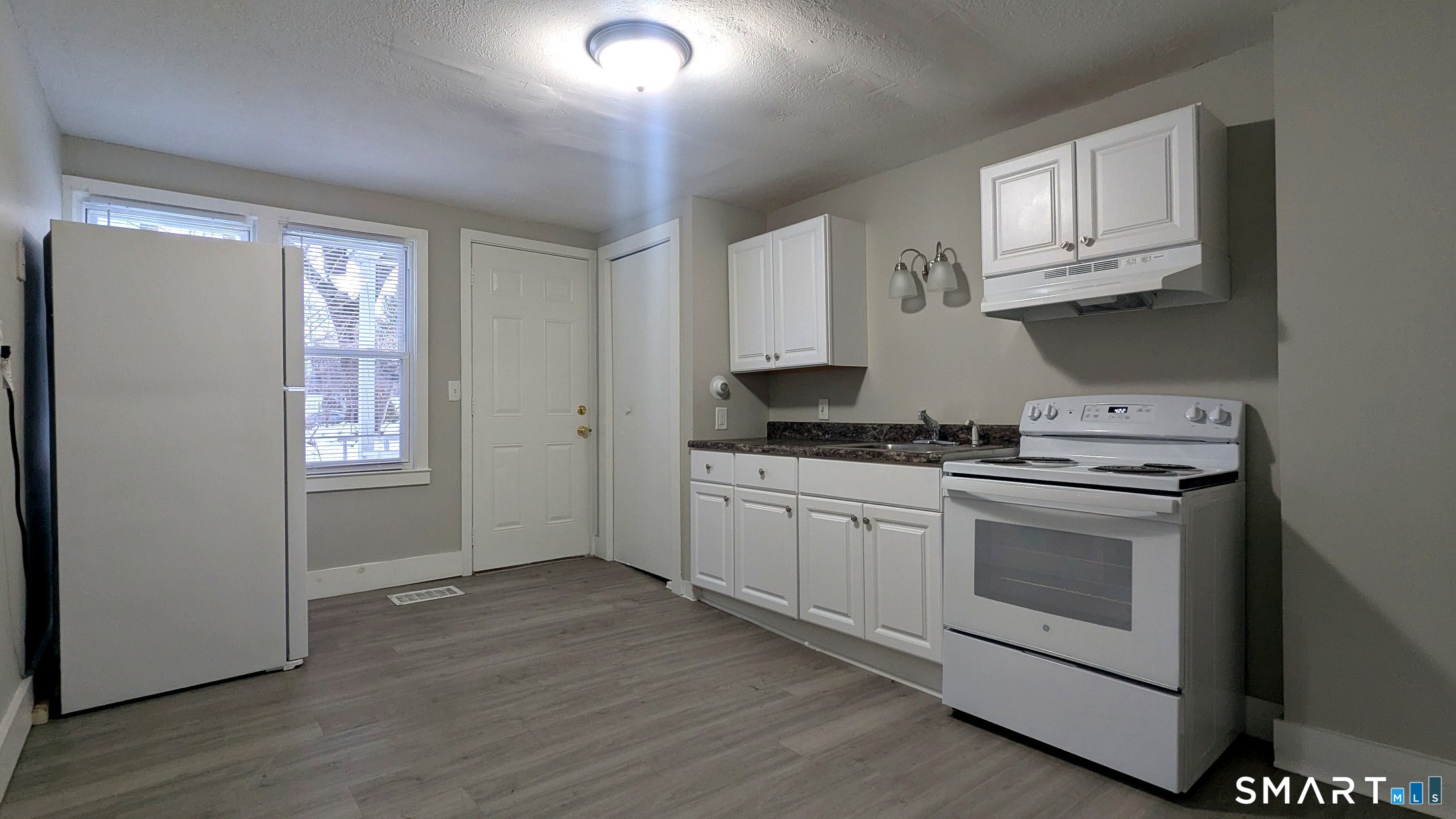 116 Old Foxon Road East Haven, CT 06513 - Photo 14 of 35 a kitchen with stainless steel appliances granite countertop a stove a sink and a microwave