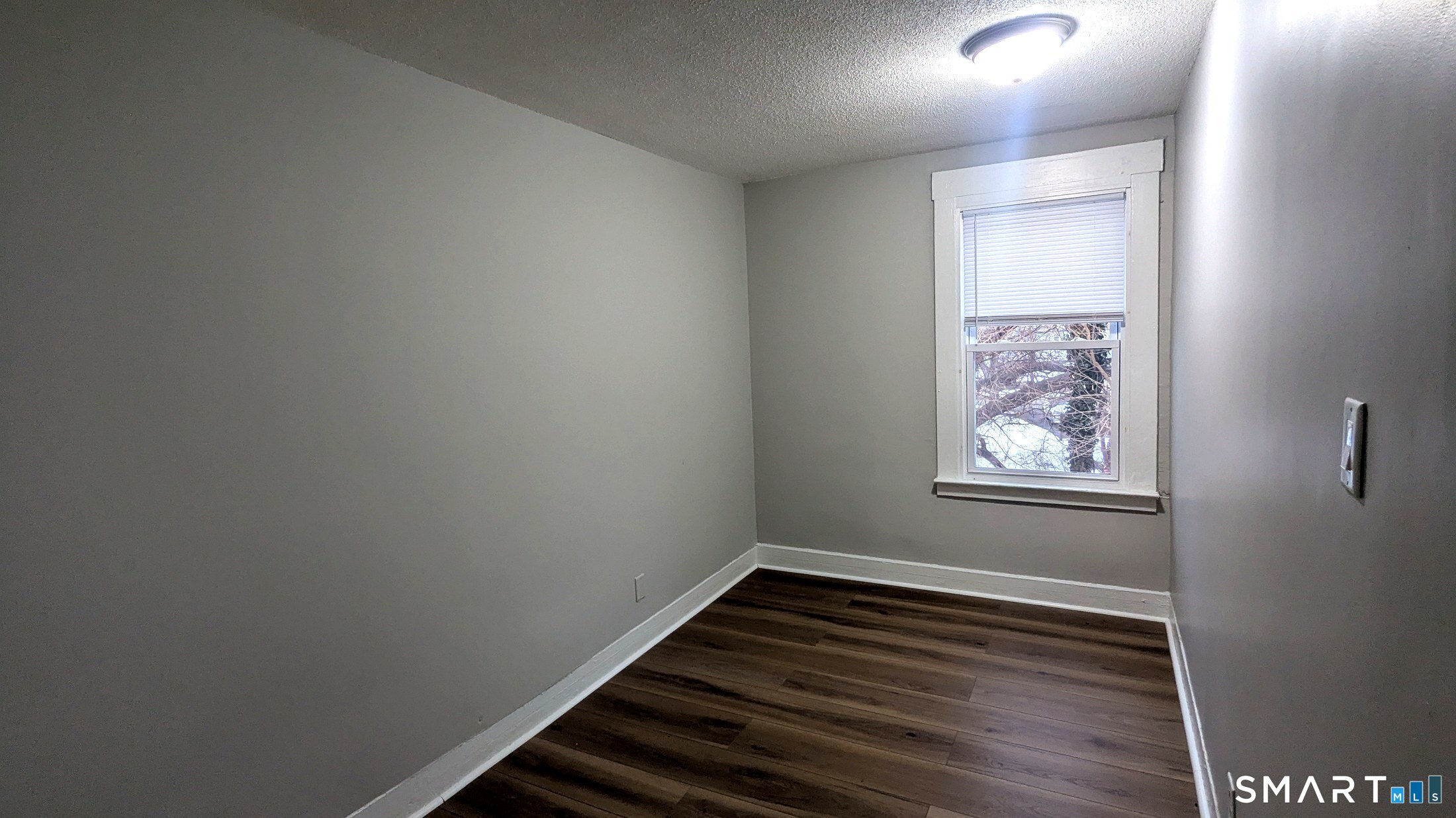 116 Old Foxon Road East Haven, CT 06513 - Photo 17 of 35 a view of an empty room with wooden floor and a window