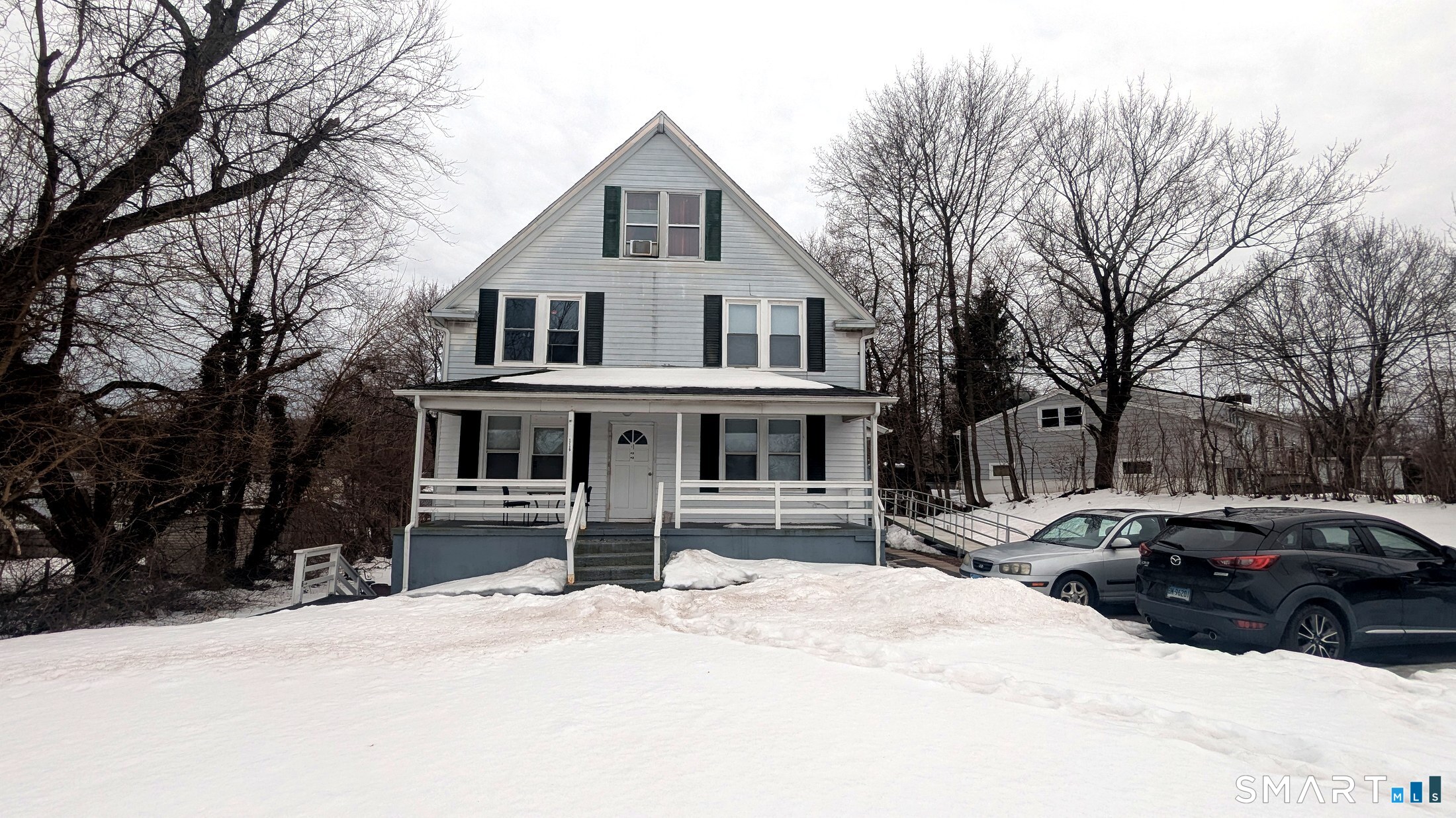 116 Old Foxon Road East Haven, CT 06513 - Photo 24 of 35 a front view of a house with a yard covered in snow