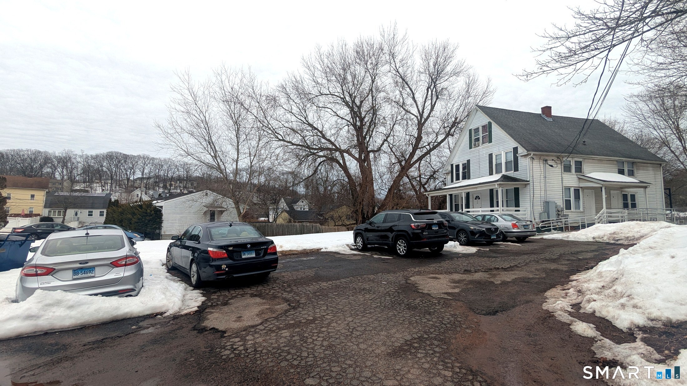 116 Old Foxon Road East Haven, CT 06513 - Photo 26 of 35 a car parked in front of a white house