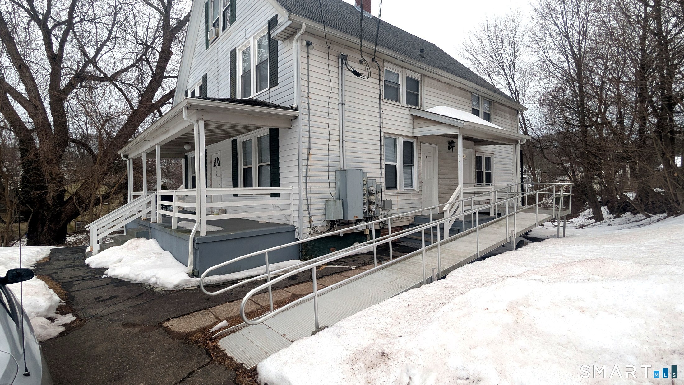 116 Old Foxon Road East Haven, CT 06513 - Photo 28 of 35 a view of a white house with large windows and couches chairs