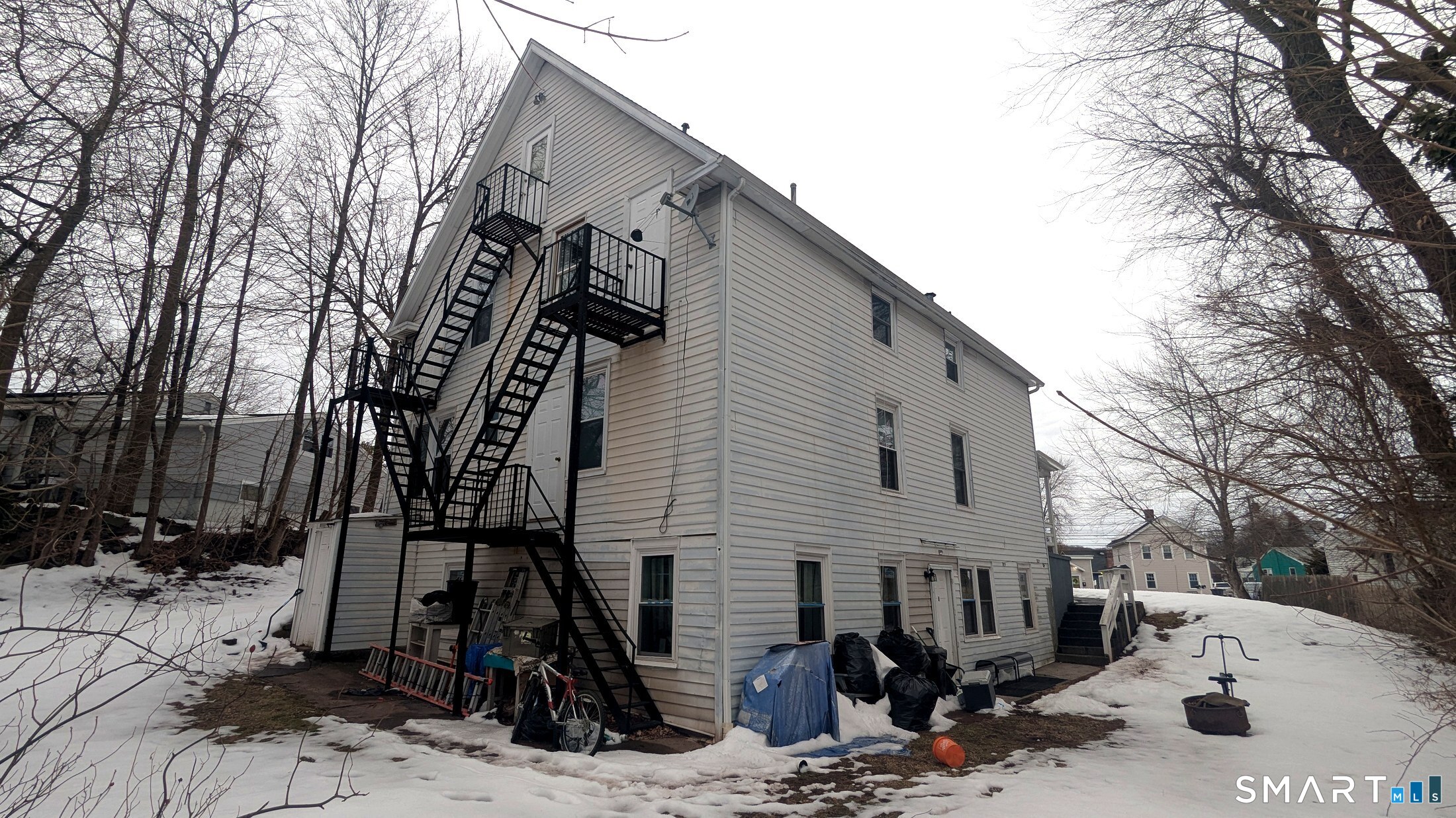 116 Old Foxon Road East Haven, CT 06513 - Photo 31 of 35 a street view with wooden fence and large trees