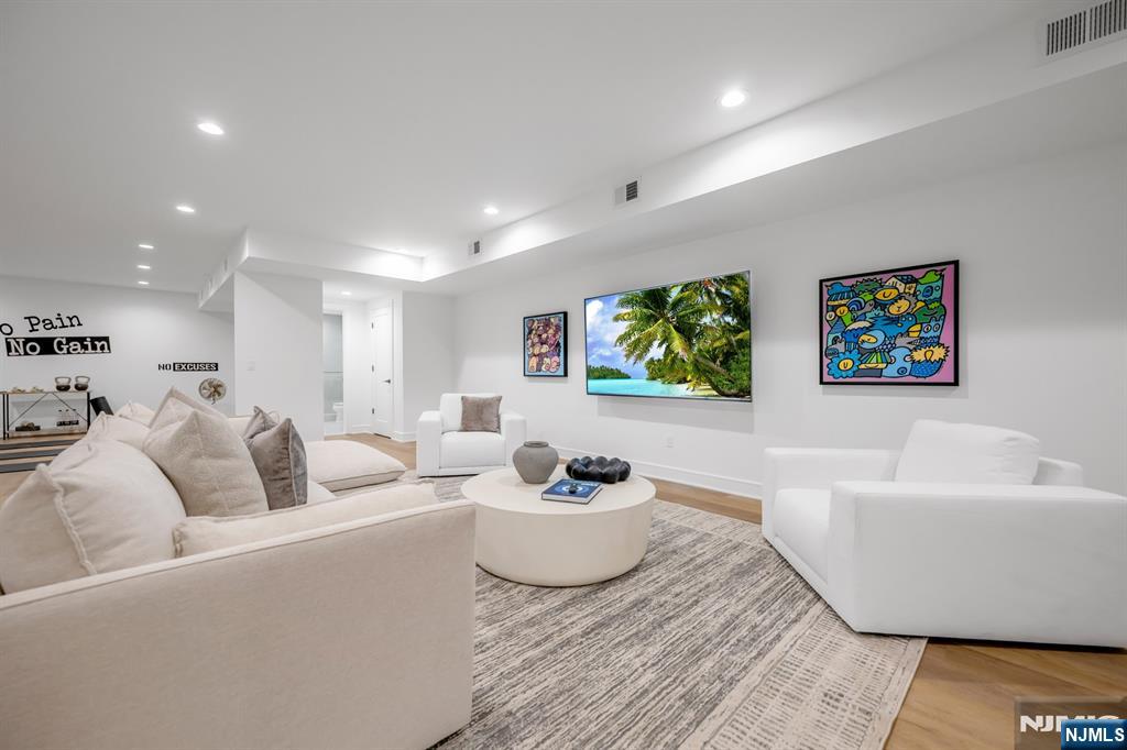 17 Feldman Court Paramus, NJ 07652 - Photo 40 of 47 a living room with furniture and a potted plant