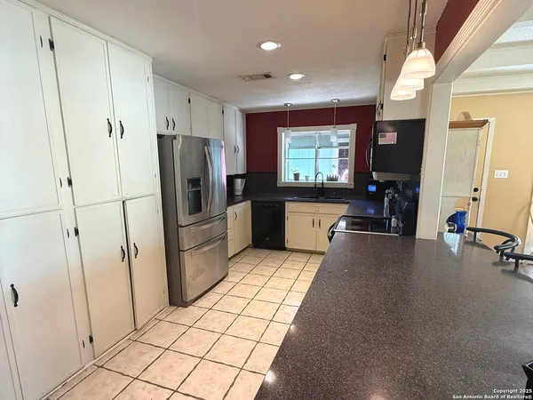 a kitchen with stainless steel appliances a refrigerator and microwave