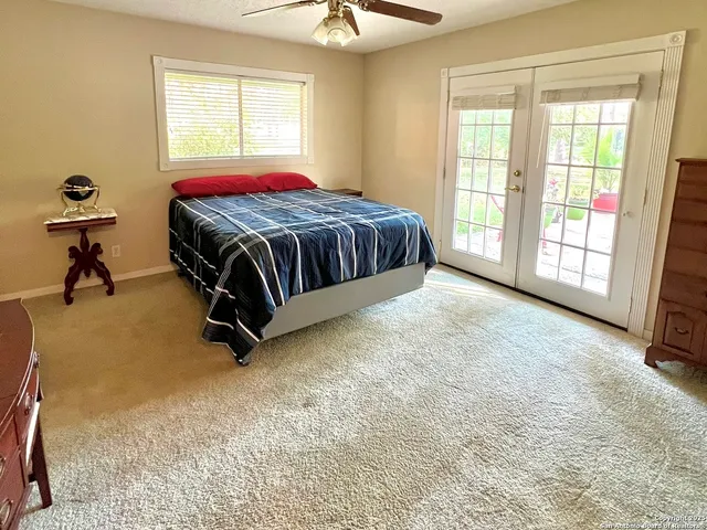 a spacious bedroom with a bed and a chandelier