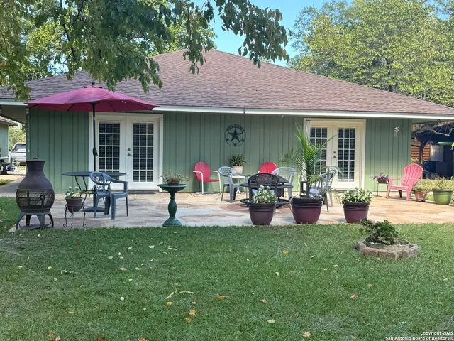 a group of people sitting in front of a house