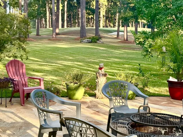 a swimming pool with outdoor seating and yard